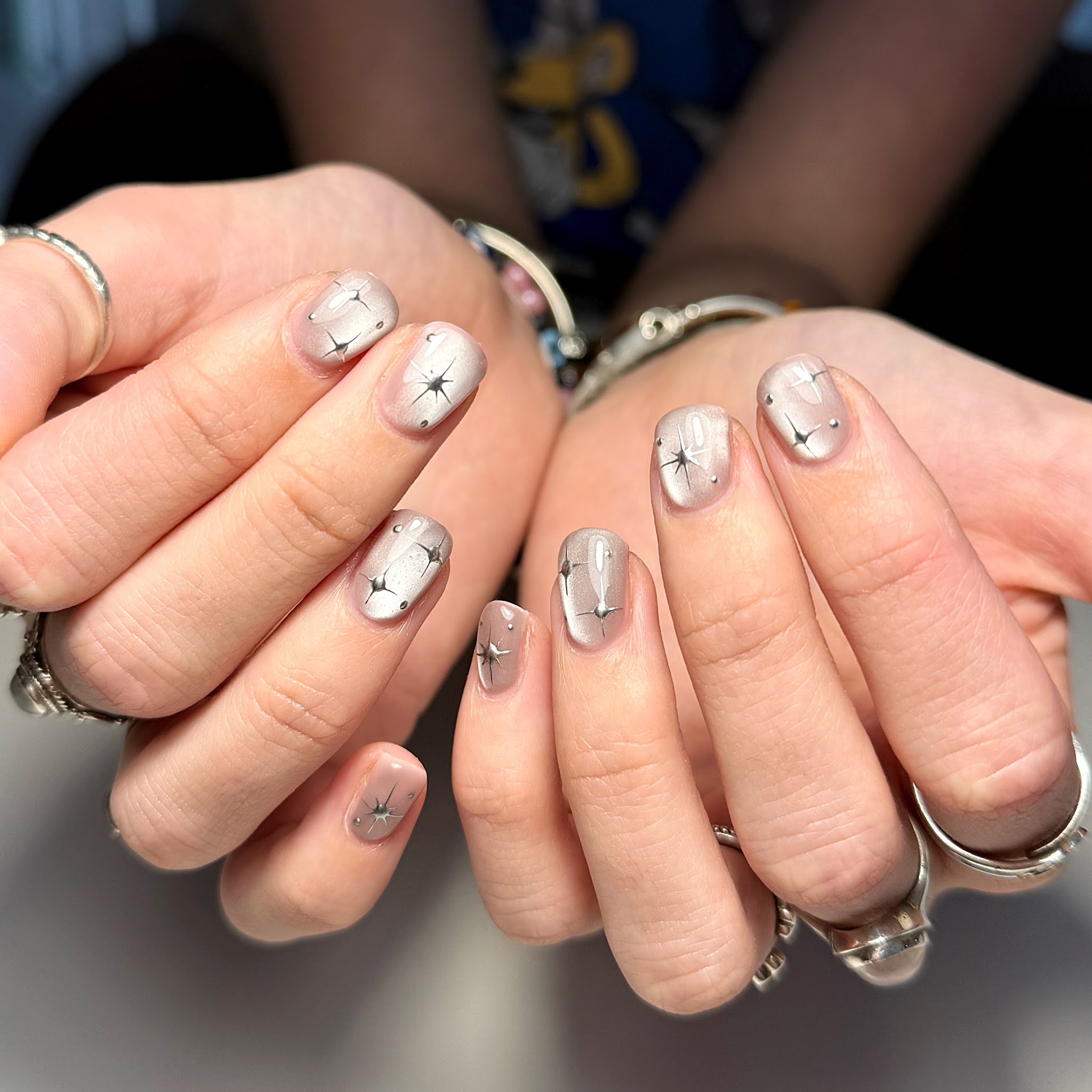 Milky nude nails with fine silver four-point stars