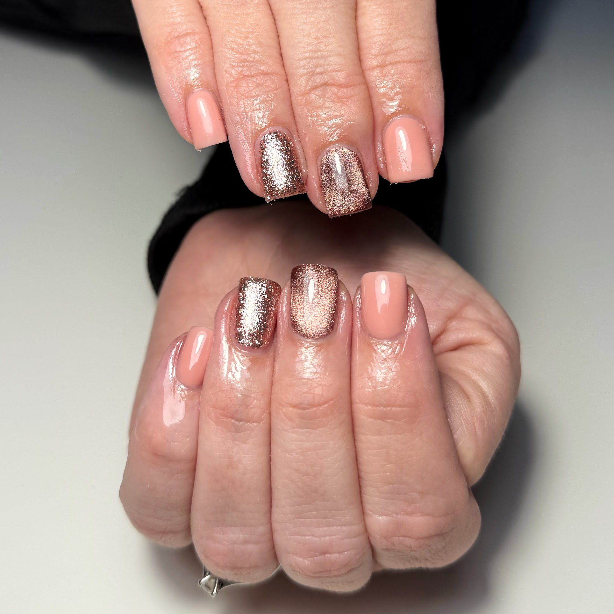 Nude nails with rose gold glitter feature nails