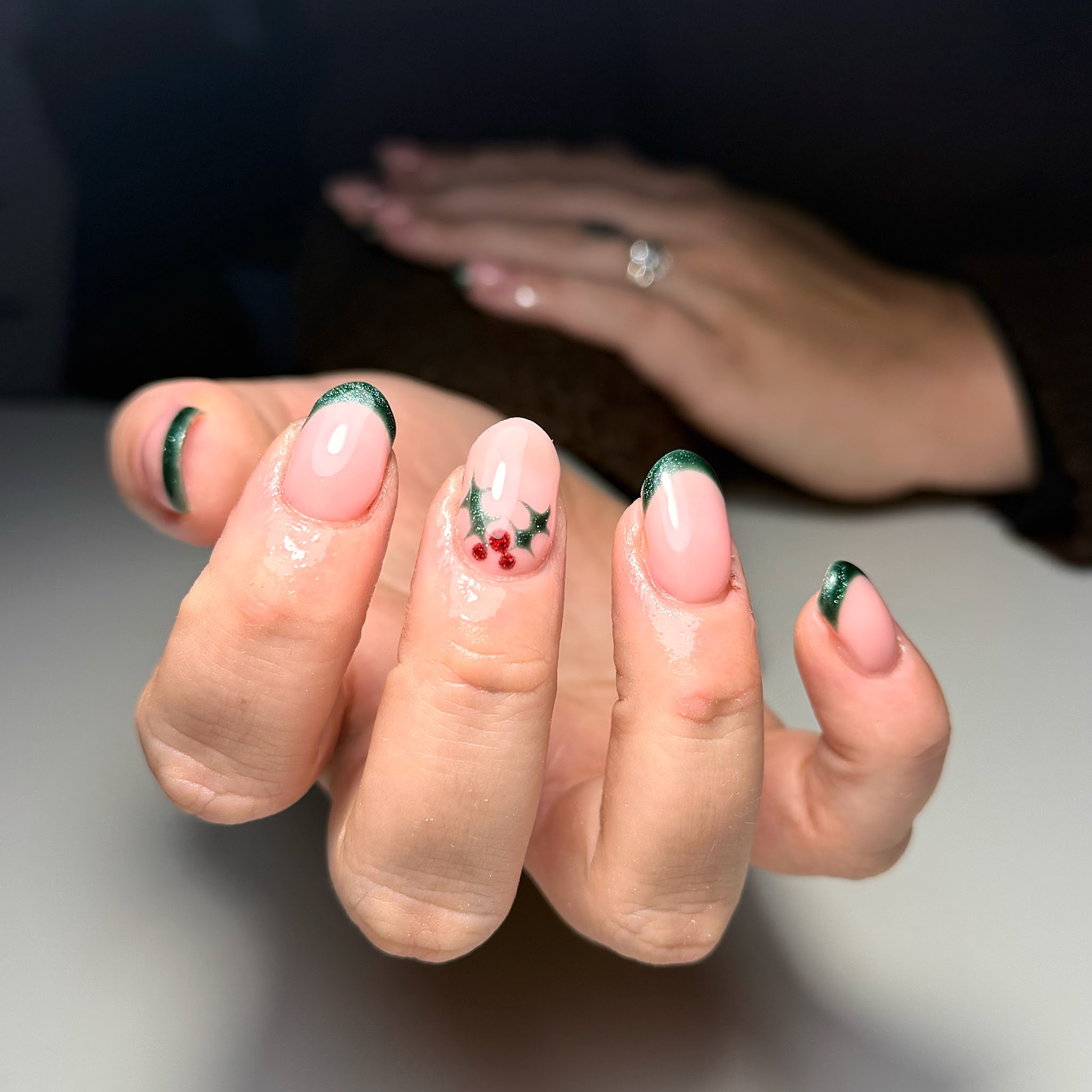 Nude nails with green French tips, holly and berries