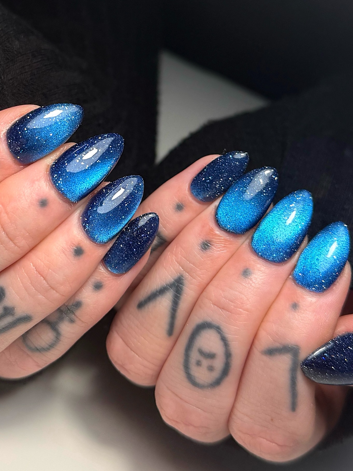 Long almond nails in sparkling blue cat eye