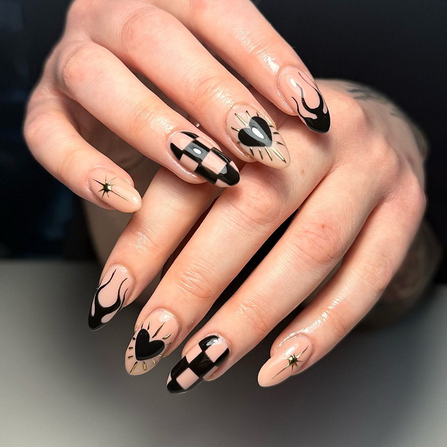 Almond nails with black flames, hearts, stars and a checkerboard