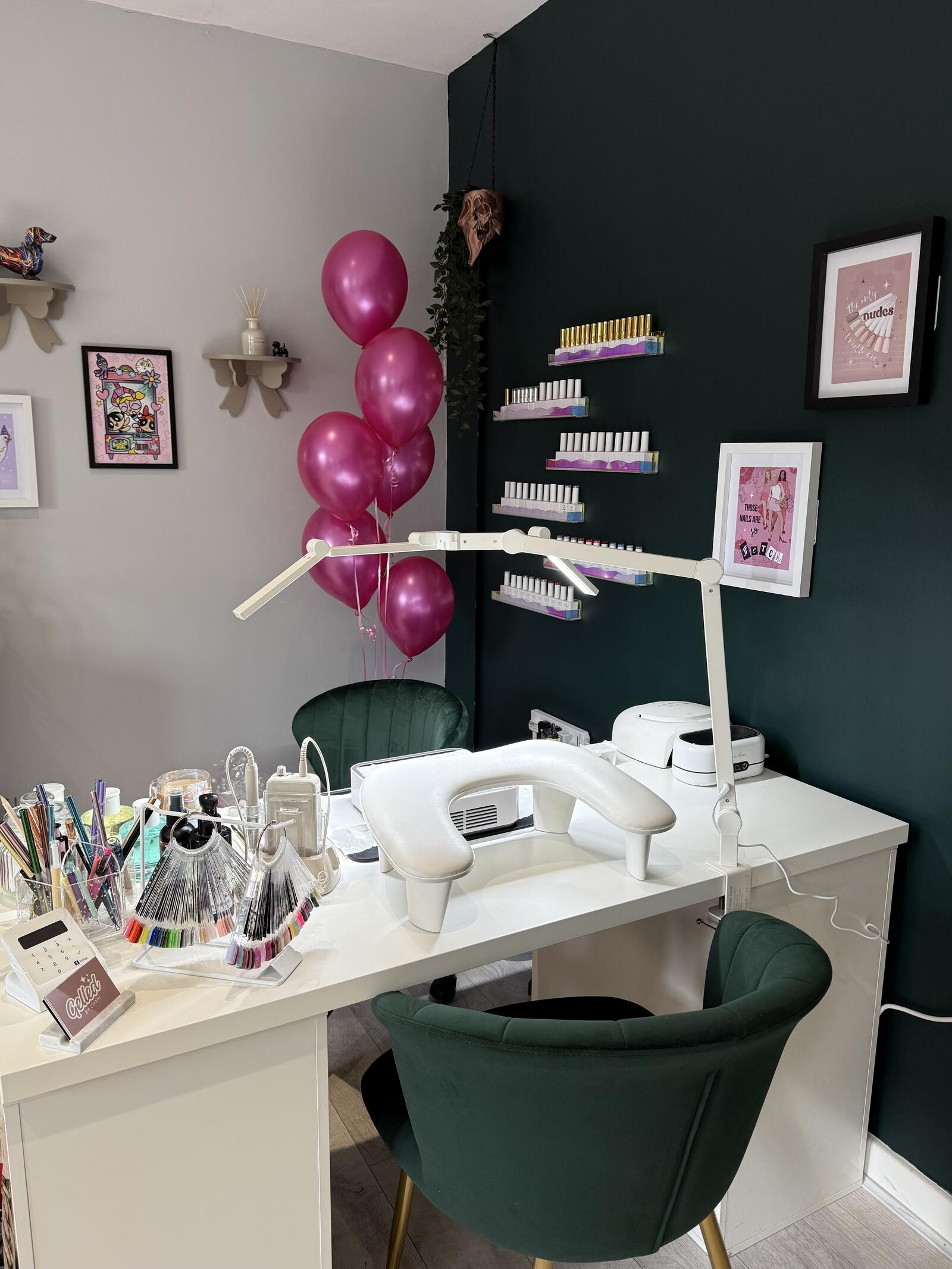Charl's nail desk with a lamp, gel polish shelves and green velvet chairs